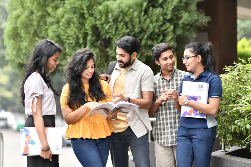 Pakistani students standing and talking on a UK university campus