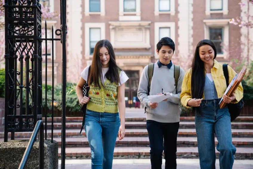 Group of students walking across a UK university campus, showcasing the opportunities for Pakistani students.