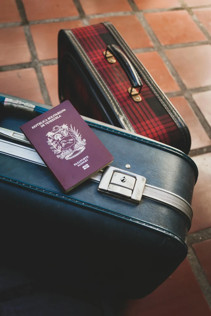 Passport and suitcase symbolizing UK visa application and IELTS for UKVI requirement